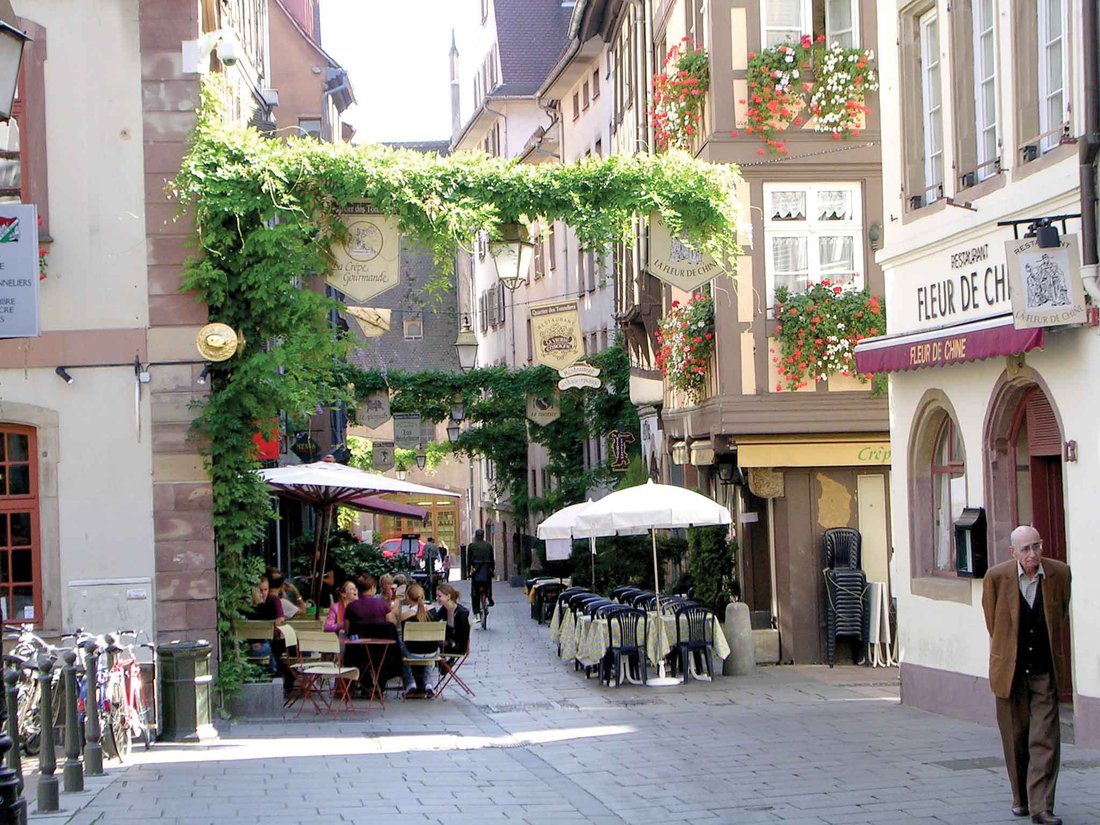 A street in Strasbourg with cafes and vines