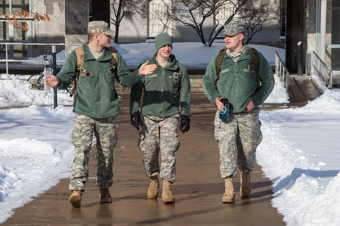 Three ROTC cadets walk on the quad