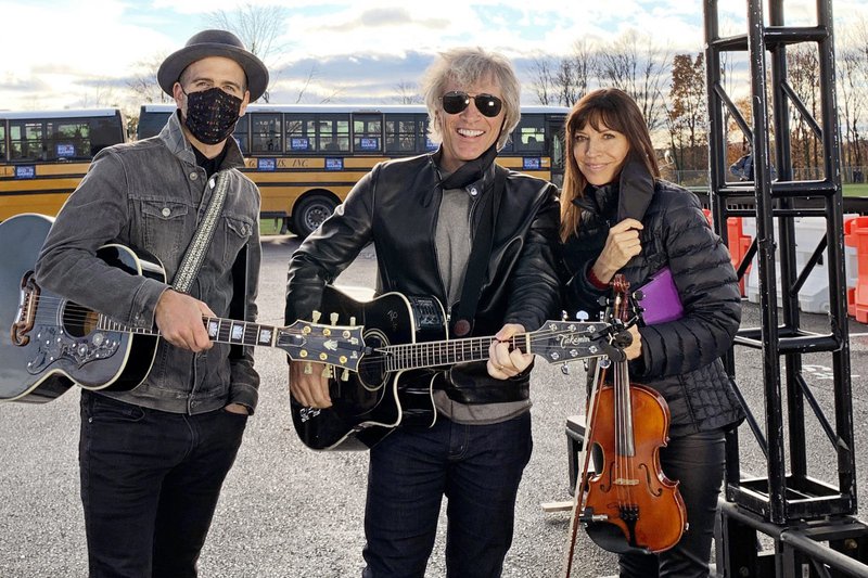 Three musicians pose with their instruments. Click to read the story.