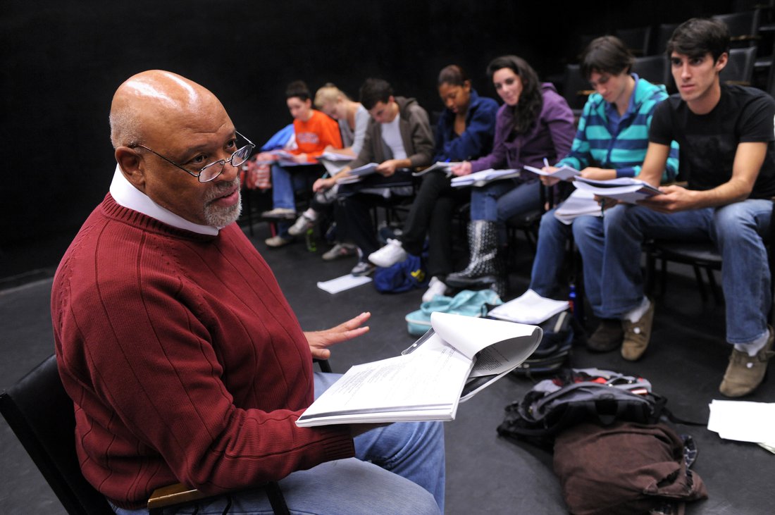 Drama professor reviewing script with class