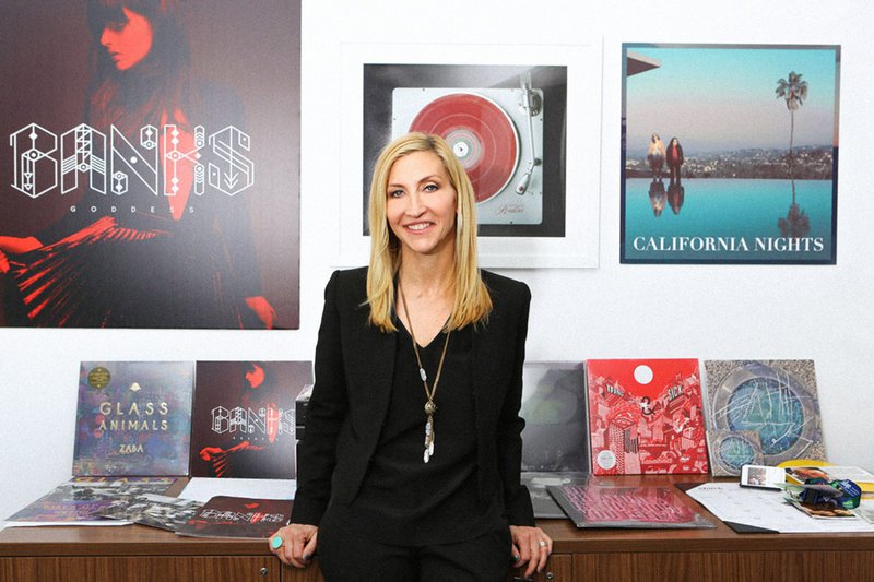 Jacqueline Saturn stands in her office, which is decorated with album covers
