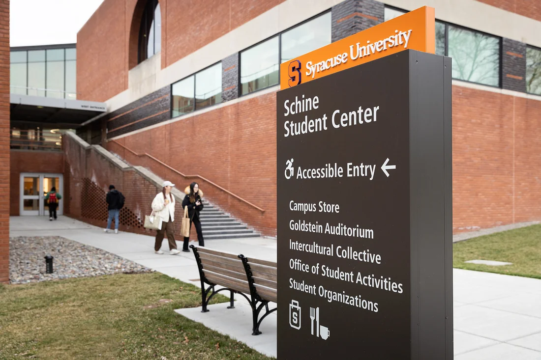 Signage in front of Schine Student Center pointing out accessible building entrances.