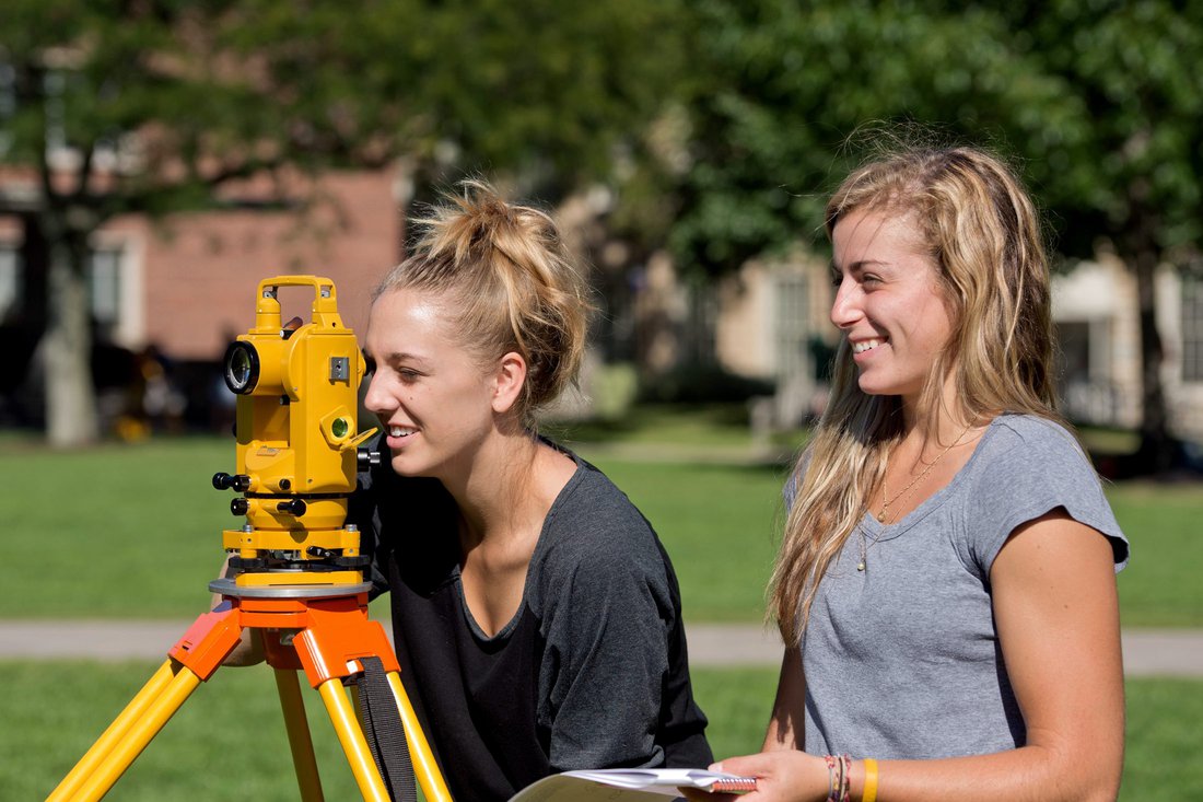 Civil engineering students surveying land on campus