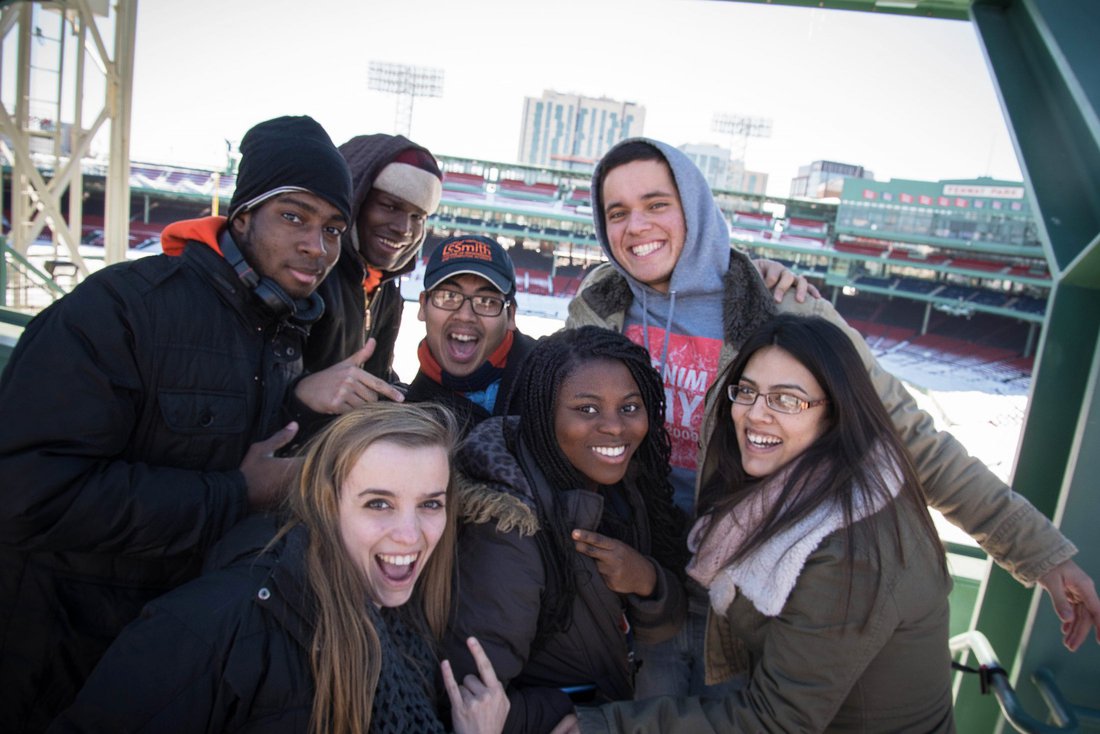 Members of a learning community pose for a photo at a baseball field