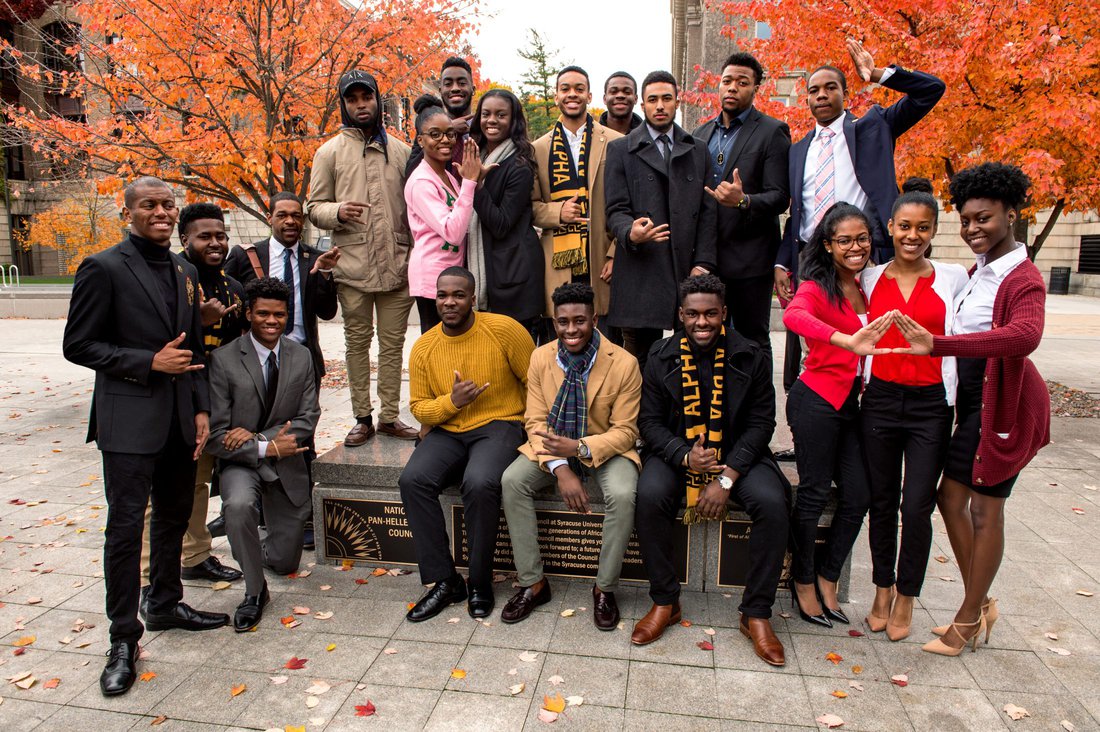 Greek life students pose for a group photo at the Orange Grove in autumn
