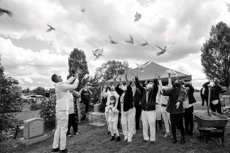 Family members release doves during the funeral of Dol Oth at Woodlawn Cemetery