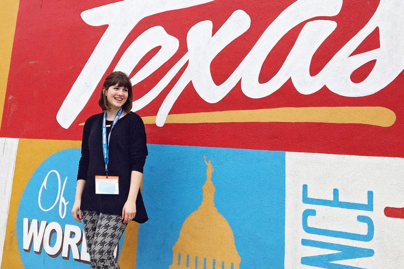 Beckman poses in front of a mural in Austin, Texas