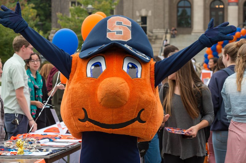 Otto poses in front of students at the involvement fair