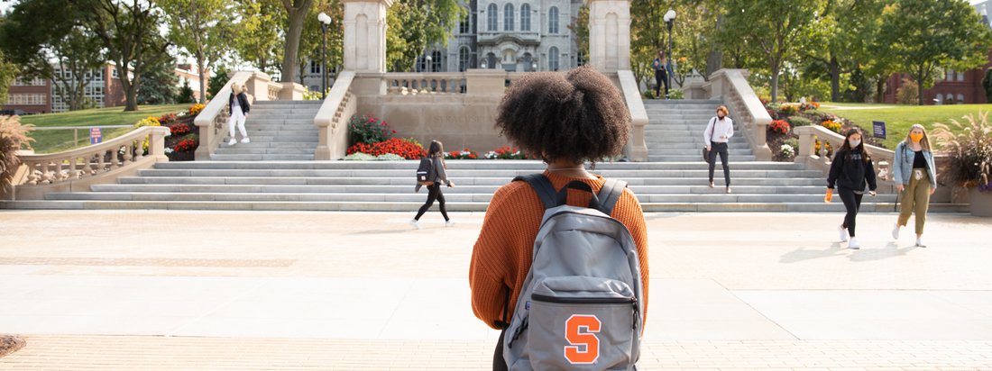 Student with a Syracuse Backpack on the quad