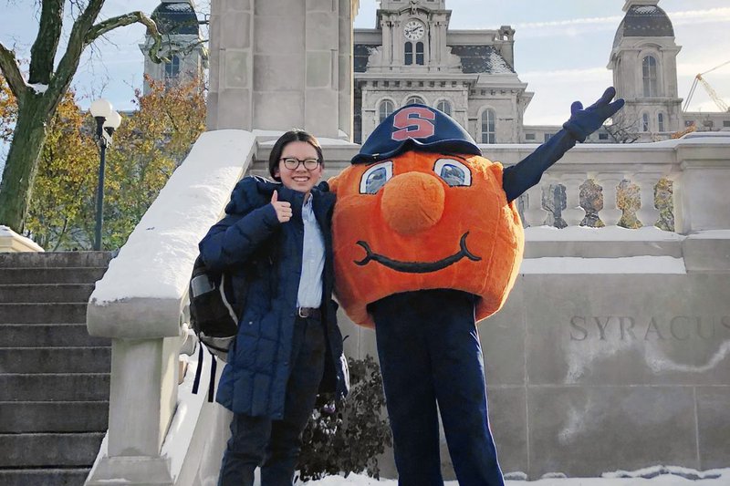 Portrait of Lia Chabot with Otto the orange. Click to read her story