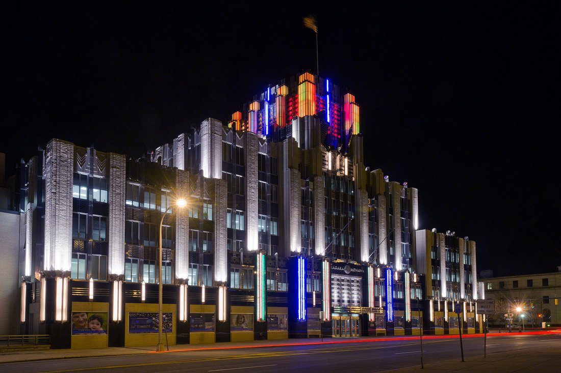 Syracuse's famous art deco Niagara Mohawk Building at night with its lights lit up in orange